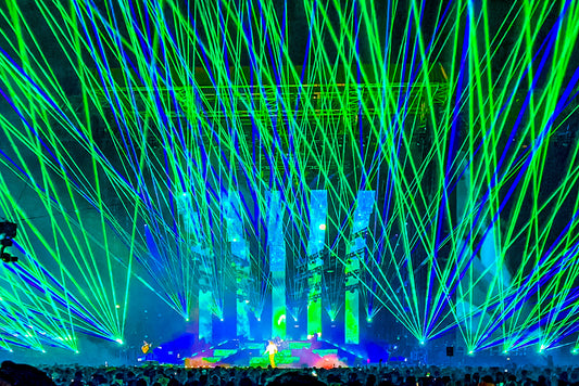Green and Blue laser beams shine overhead of the audience.